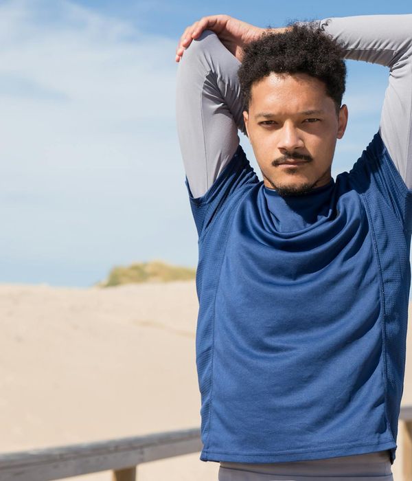 A man stretching outdoors feeling energetic and refreshed.